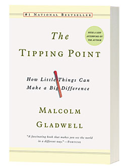 The cover of "The Tipping Point," featuring dark green text on a light tan background and a small image of an unlit match