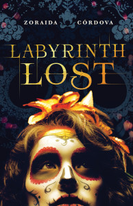 Cover of "Labyrinth Lost," featuring gold text on a dark background above the head (from the nose up) of a brown-haired girl in sugar skull makeup