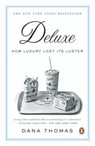 Cover of "Deluxe," featuring what looks like a McDonald's meal on a tray, but instead of McDonald's logo and colors, it is covered with Prada branding