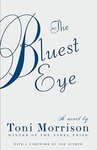 Cover of "The Bluest Eye," featuring the title in dark blue script on a light silver background.