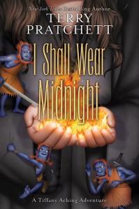 Cover of the book, featuring a pair of hands holding fire, the arms in a black robe and three small blue-skinned men with wild red hair hiding in the sleeves.
